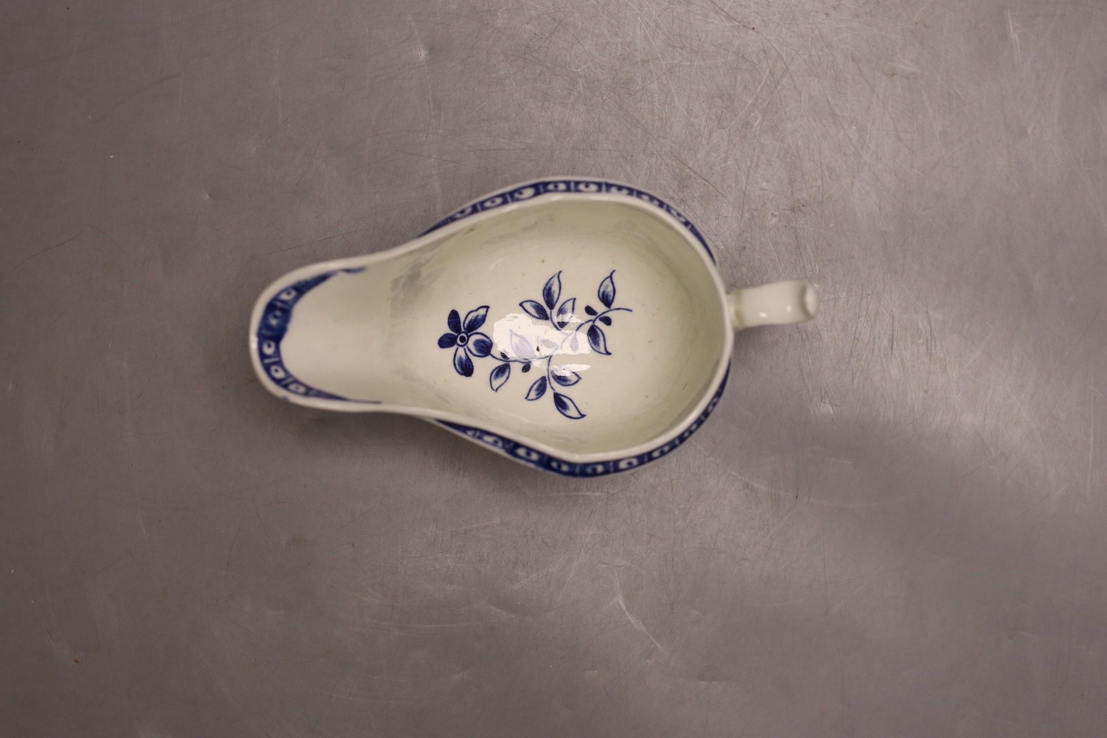 A Worcester sauceboat painted with the Strap Fluted Floral pattern c. 1768-72, 16.5 cms wide.